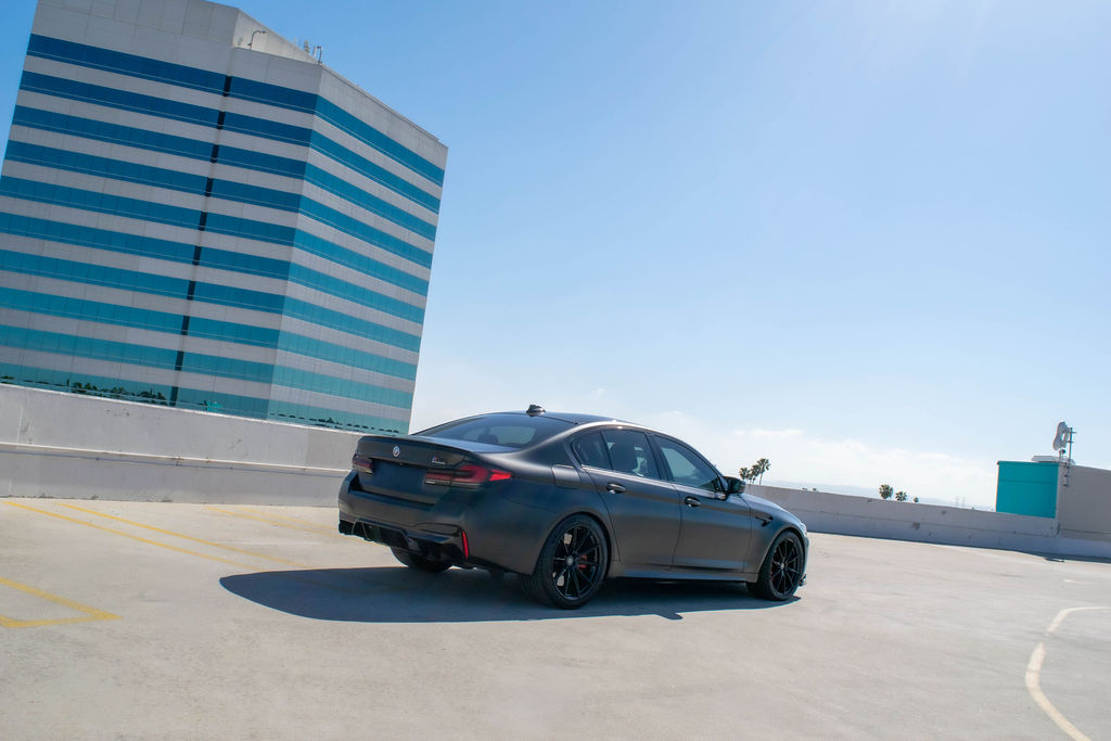 Black BMW M5 rental, a 5 seat sports sedan with all-wheel drive