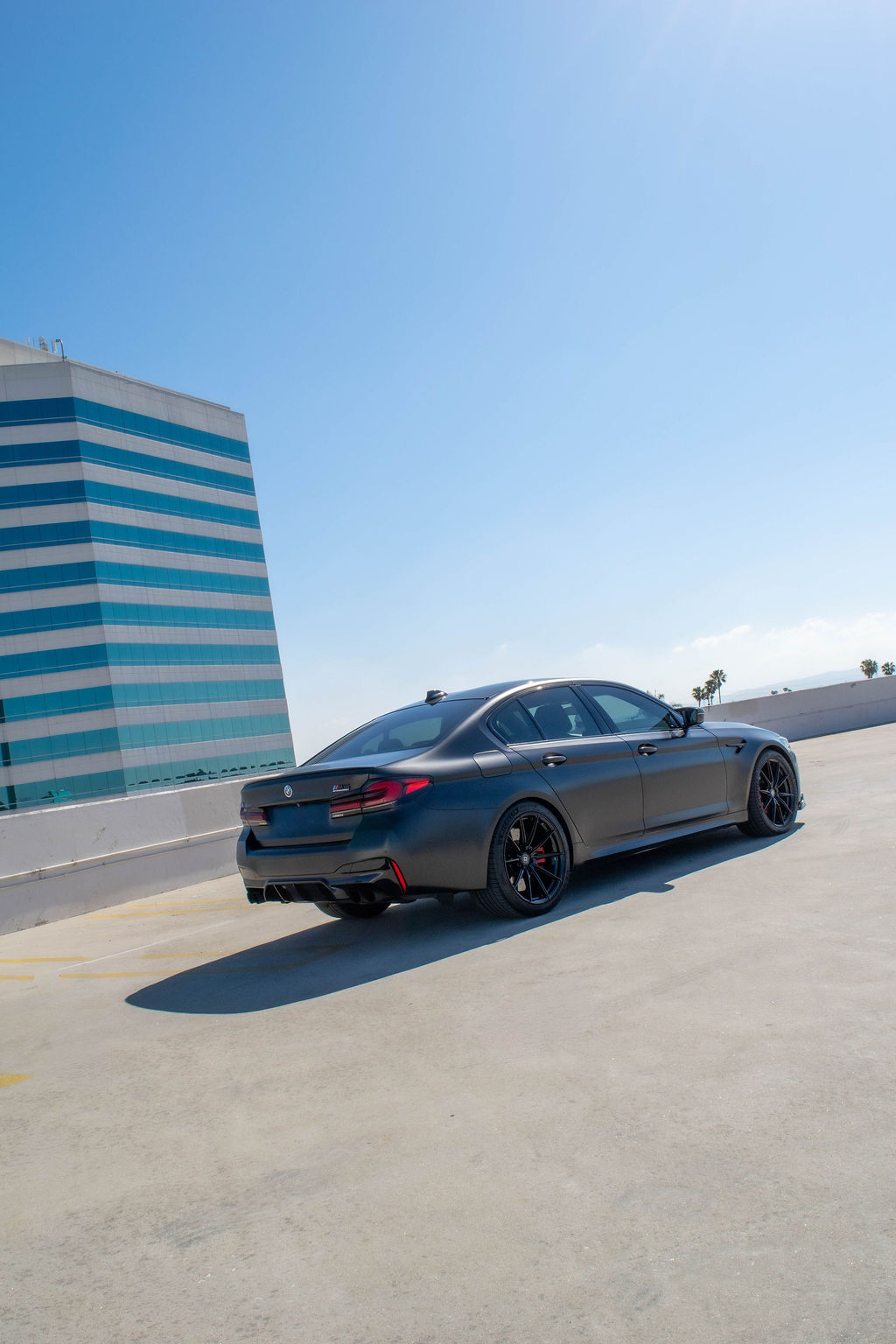 Black BMW M5 rental, an executive sedan carrying an M car V8