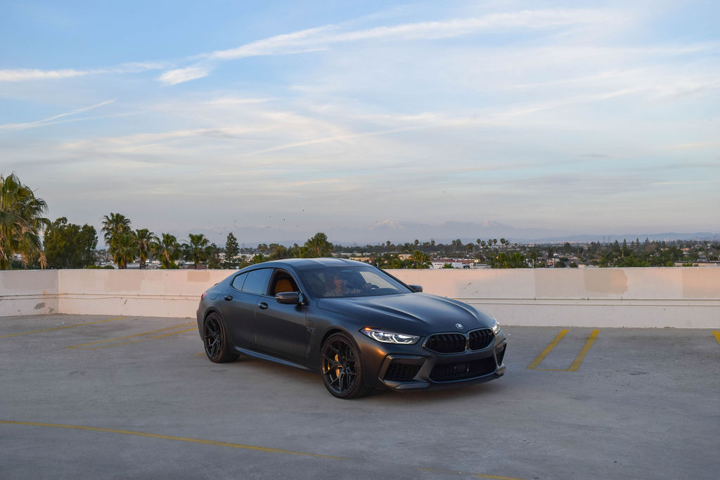 BMW M8 rental, a 617 hp twin-turbo V8 grand tourer in satin black