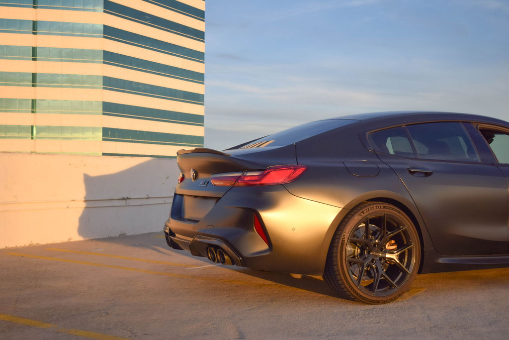BMW M8 rental in satin black, reaching 60 mph in 3.0 seconds