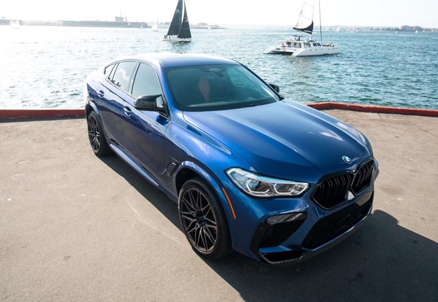 Rear view of the blue BMW X6 M rental, a 617 hp twin-turbo V8 SUV