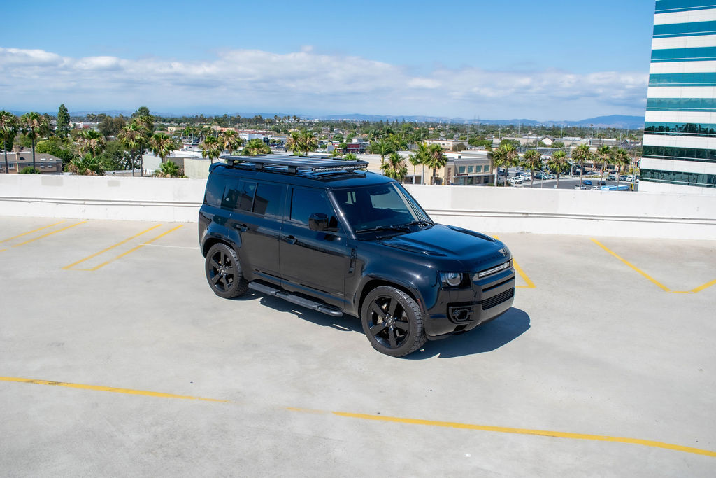 Black Land Rover Defender X rental, a 5 seat SUV on air suspension