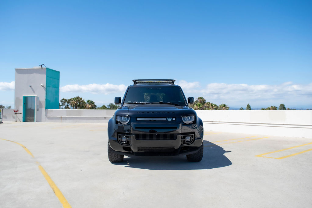 Black Land Rover Defender rental, a mild hybrid inline-six SUV