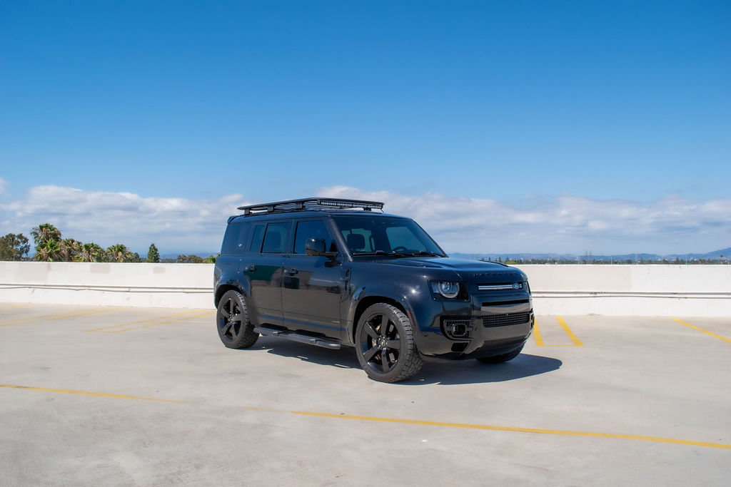 Land Rover Defender X rental in black, with 22 inch wheels and orange brake calipers