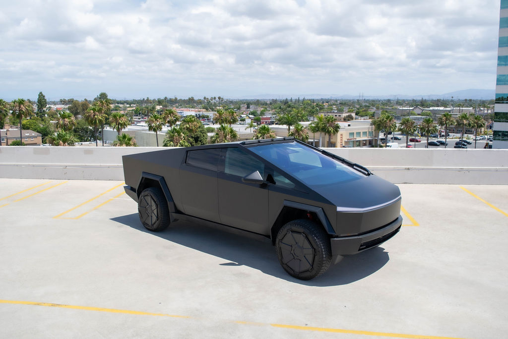 Tesla Cybertruck rental in black, a stainless steel pickup with a lockable 6 foot bed