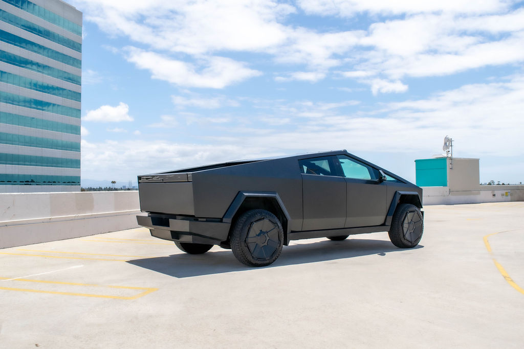 Black Tesla Cybertruck rental, an electric pickup rated to tow 11,000 pounds