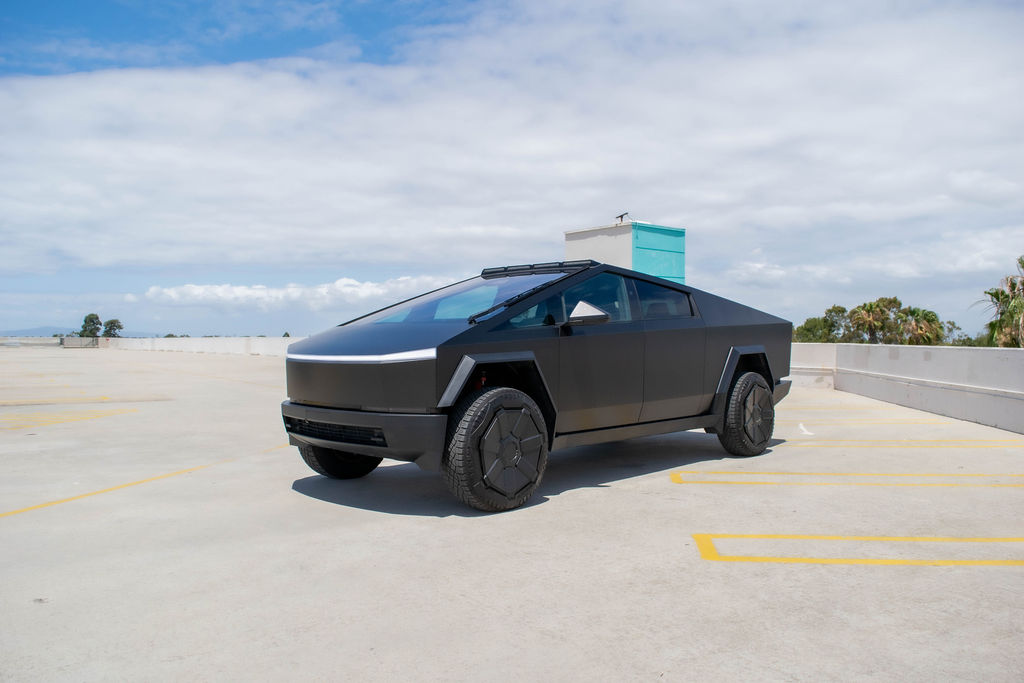 Black Tesla Cybertruck rental, an electric pickup with rear-wheel steering