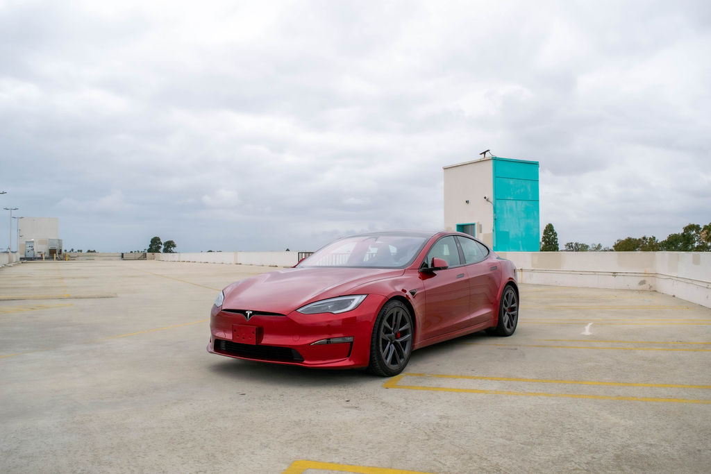 Tesla Model S Plaid rental in red, with a hatchback trunk plus a front trunk