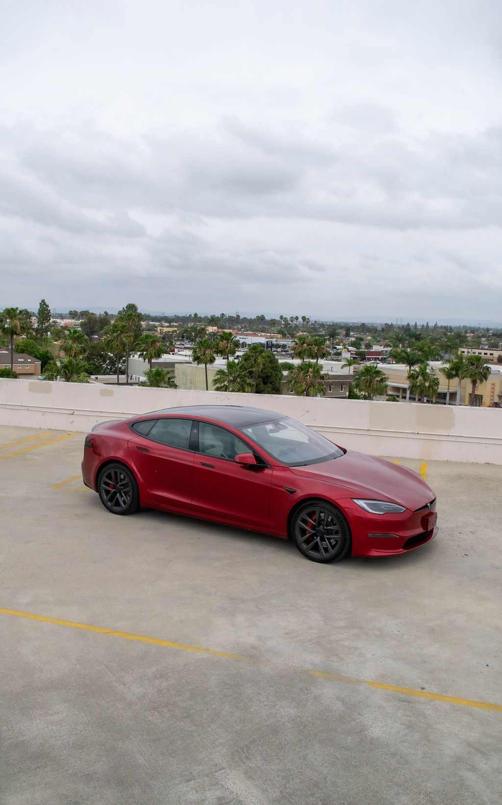 Red Tesla Model S rental, a 4 door electric sedan seating 5