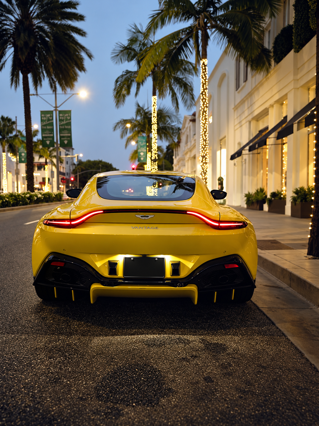 Rear view of the yellow Aston Martin Vantage rental, rear-wheel drive V8
