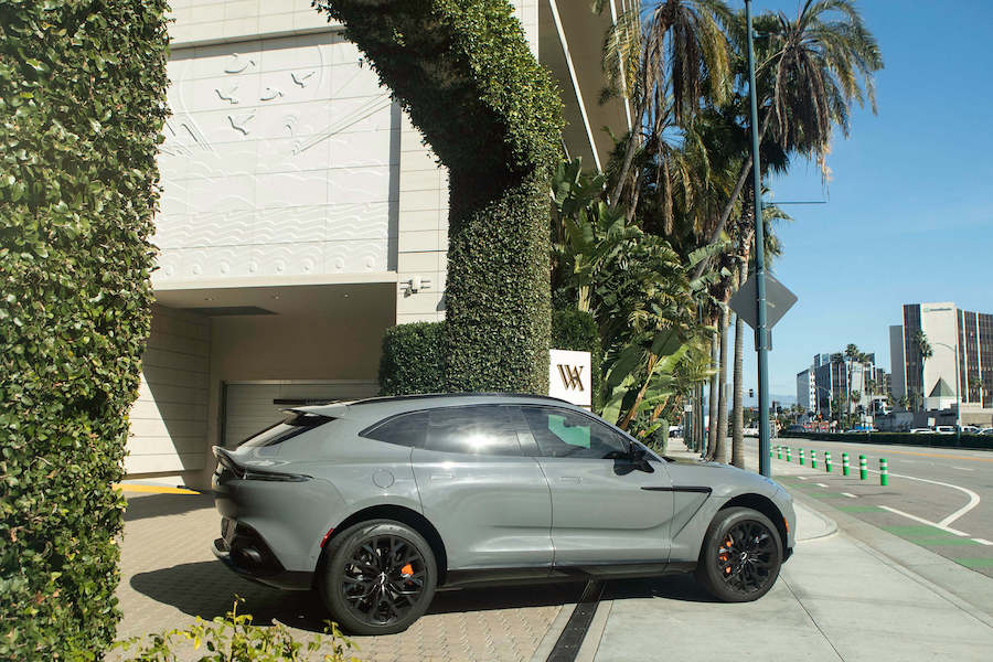 Rear view of the grey Aston Martin DBX rental, an all-wheel drive luxury SUV
