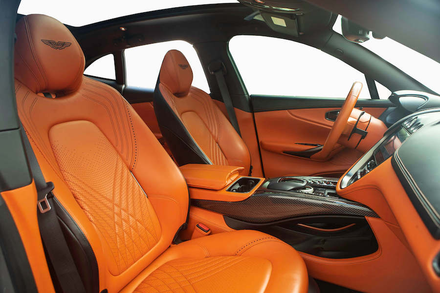 Orange seats inside the Aston Martin DBX rental, a 5 seat luxury SUV
