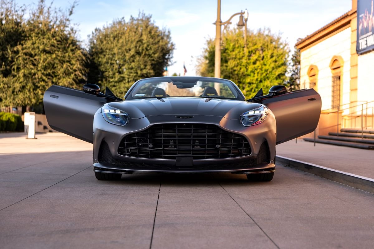Grey Aston Martin DB12 Volante front with doors open, rental in Los Angeles