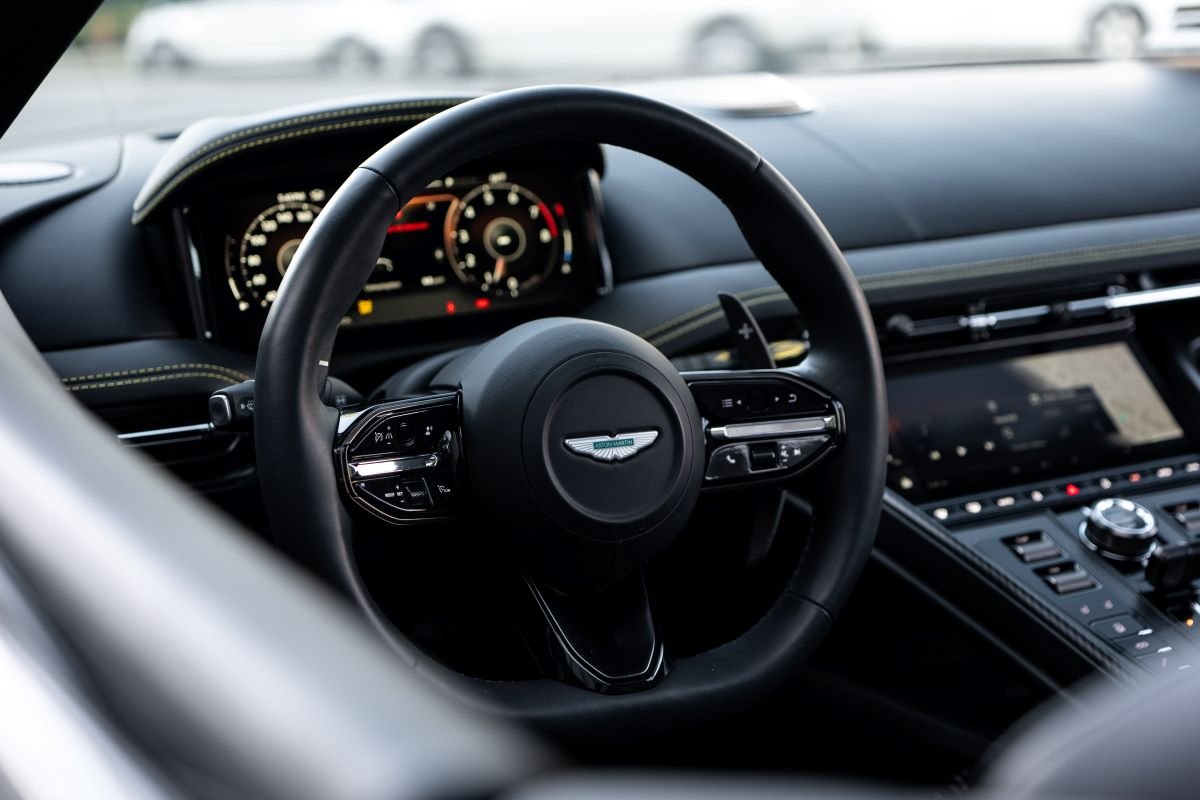 Grey Aston Martin DB12 Volante interior steering wheel, rental in Los Angeles
