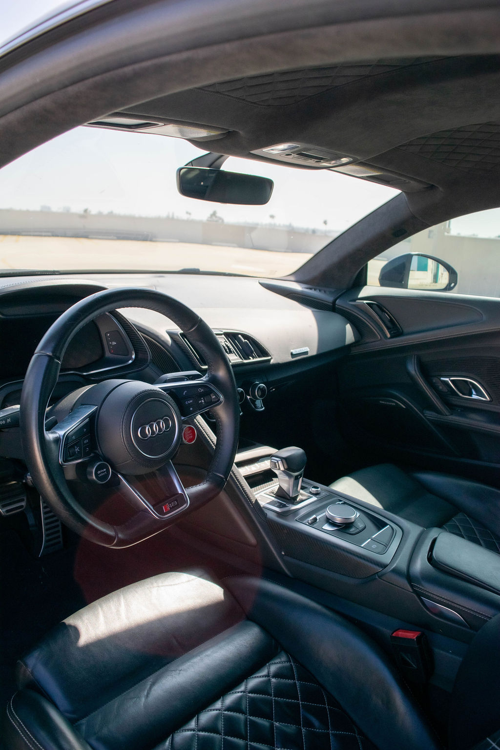 Black Audi R8 V10 Coupe with AWD drivetrain, supercar rental in Orange County