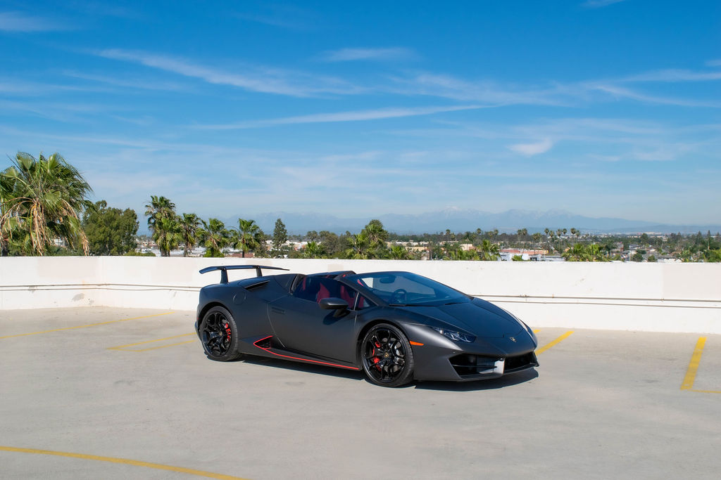 Black Lamborghini Huracan Spyder convertible supercar for rent in Orange County