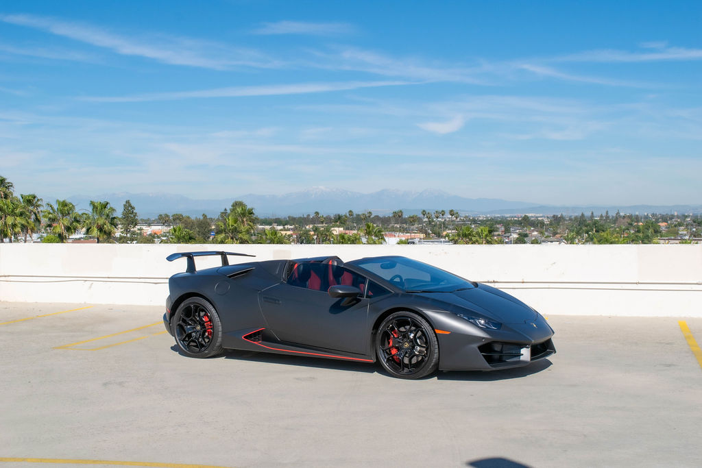 Black Lamborghini Huracan Spyder convertible supercar rental in Orange County