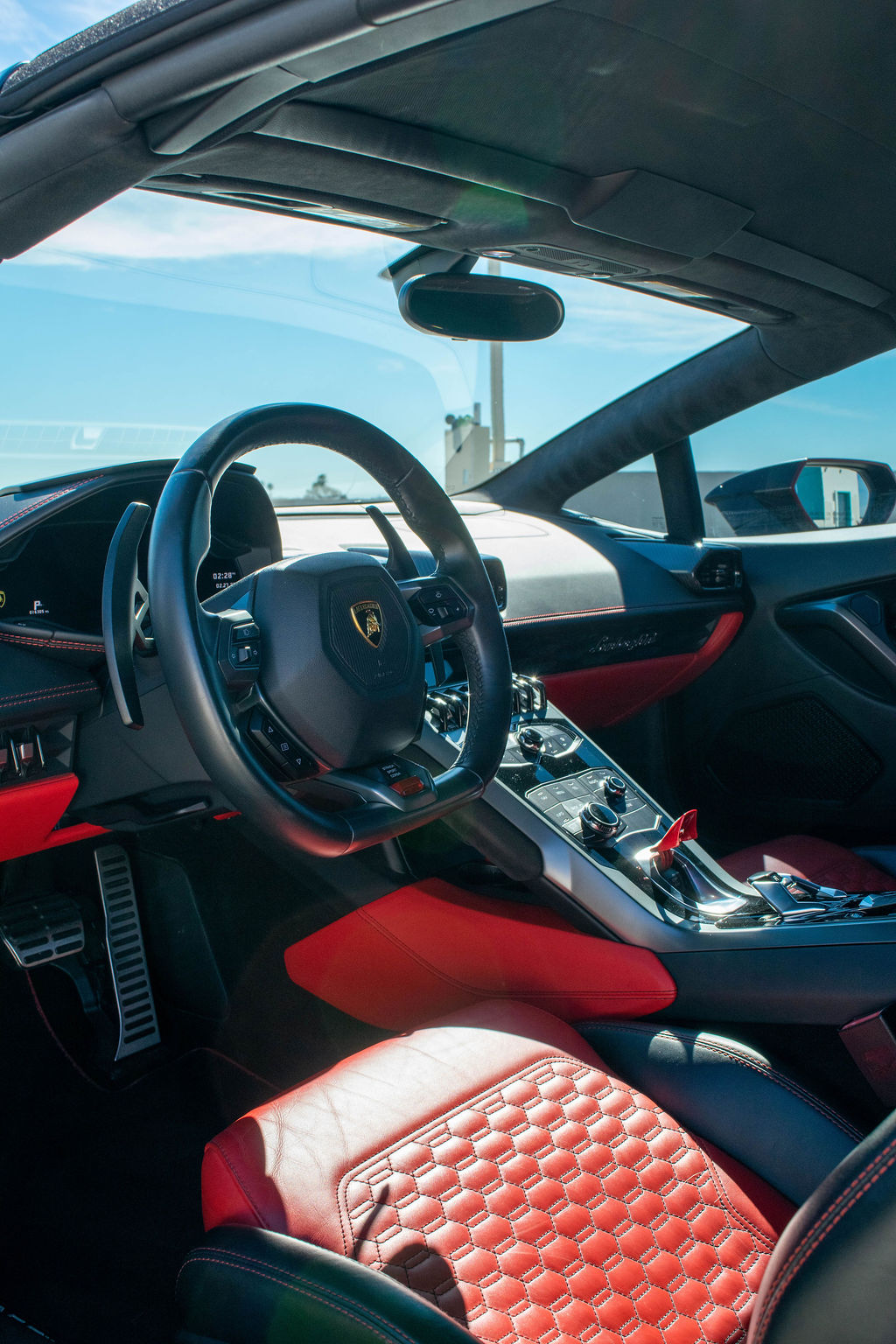 Black Lamborghini Huracan Spyder supercar with Red interior