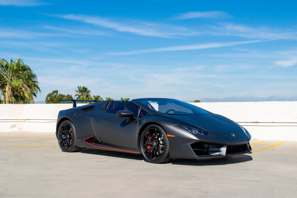 Black Lamborghini Huracan Spyder 2 seat supercar with Red interior