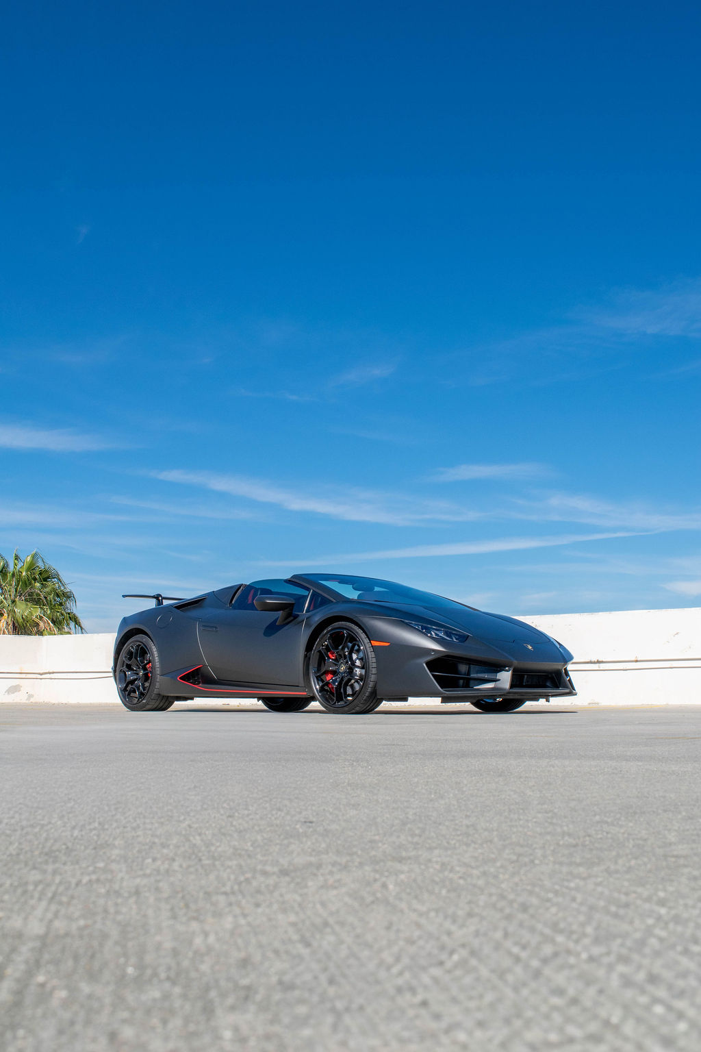 Black Lamborghini Huracan Spyder 2 door supercar with Red interior
