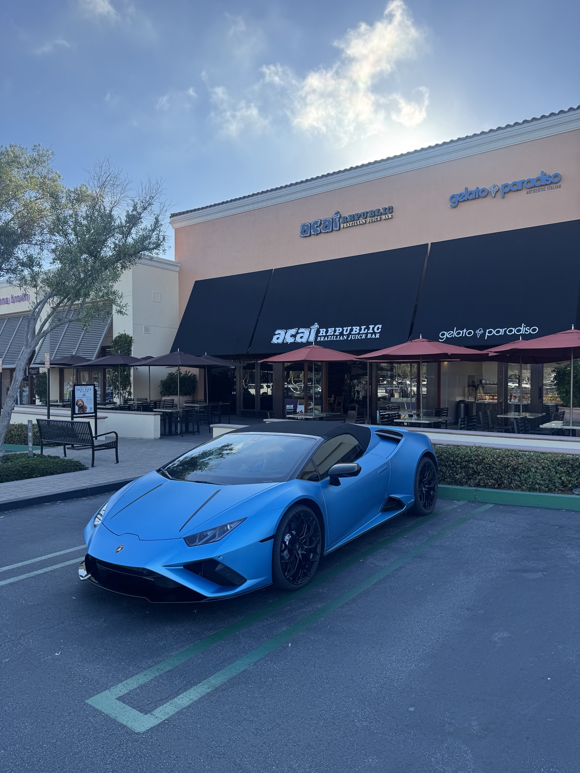 Blue Lamborghini Huracan Evo Spyder supercar for rent in Orange County, Black interior