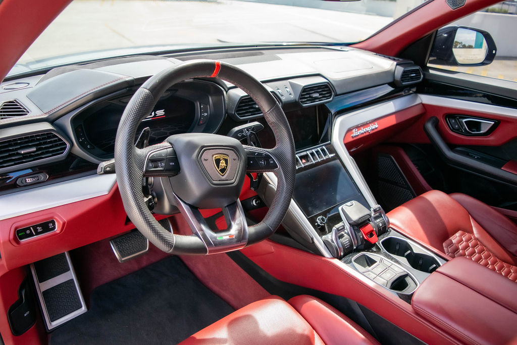 Grey Lamborghini Urus luxury SUV rental in Orange County with Red interior