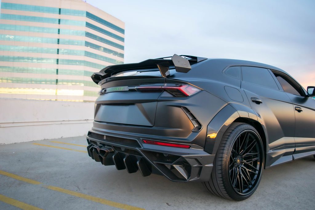 Satin Black Lamborghini Urus Mansory luxury SUV rental in Orange County with Green interior