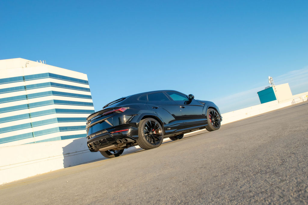 Black Lamborghini Urus S luxury SUV rental in Orange County with Black and Red interior