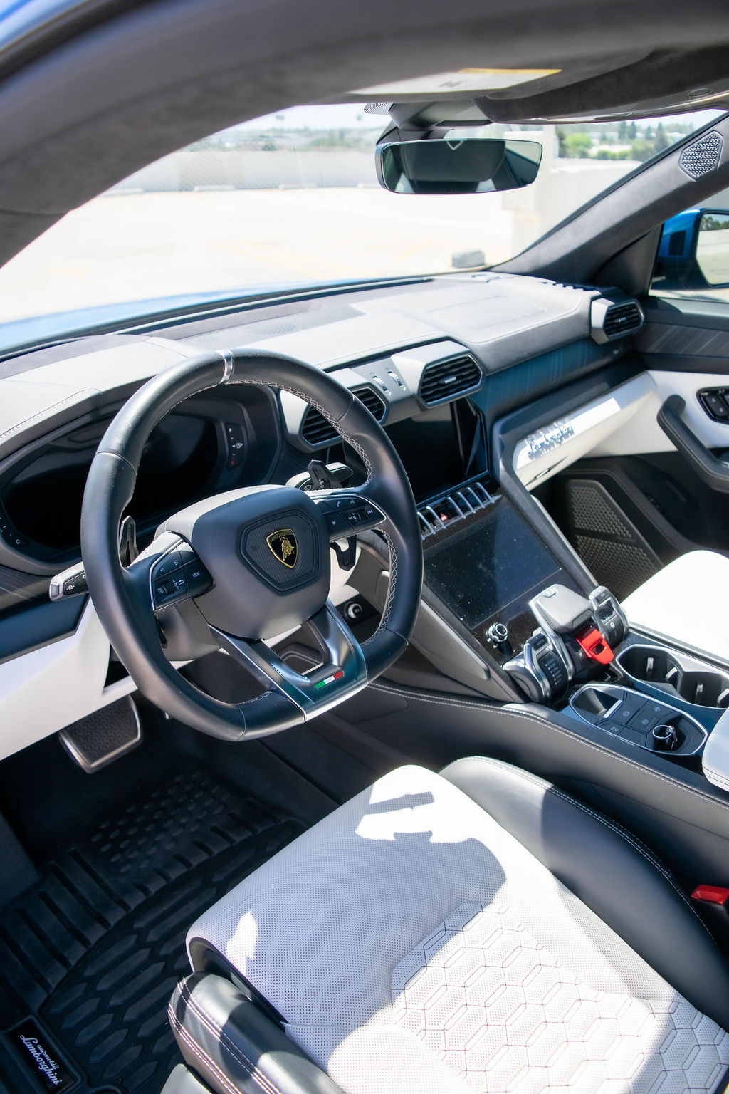 Blue Lamborghini Urus S luxury SUV with White interior