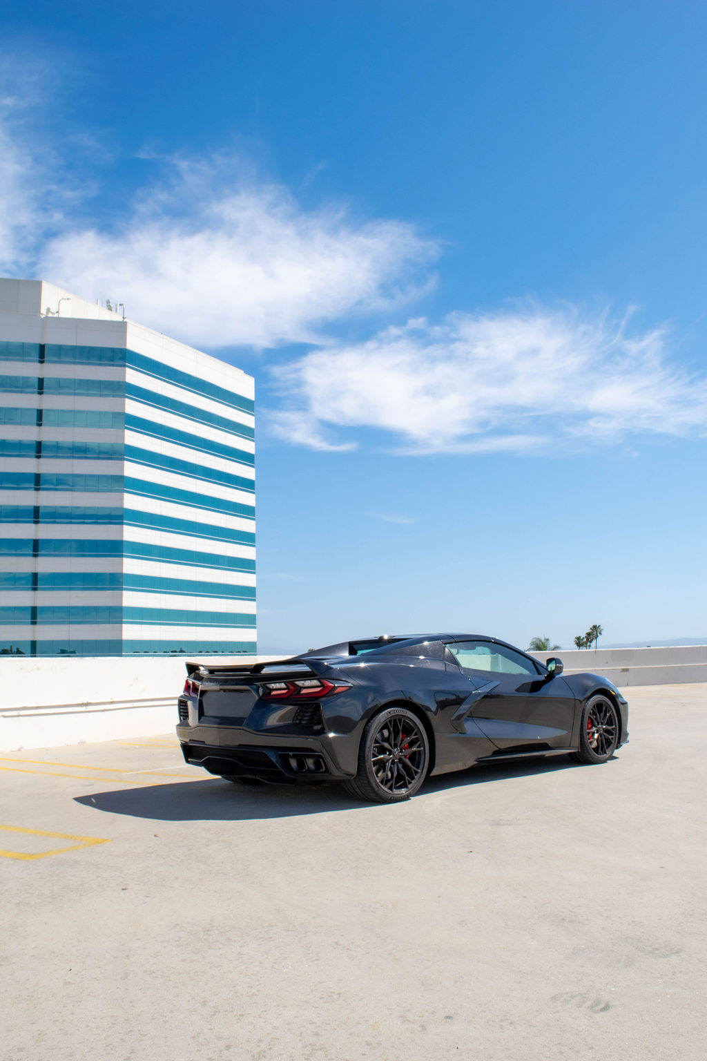 Black Chevrolet Corvette C8 Stingray with RWD drivetrain, sports car rental in Orange County, Black and Red interior
