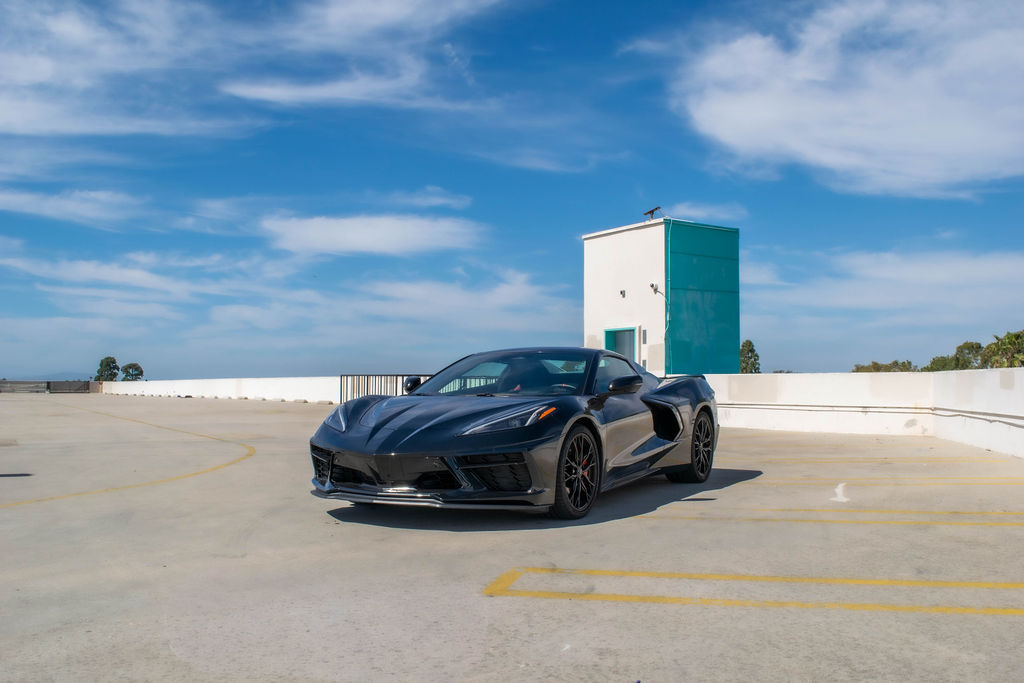 Chevrolet Corvette C8 Stingray sports car in Black, available for rental in Orange County, CA, Black and Red interior