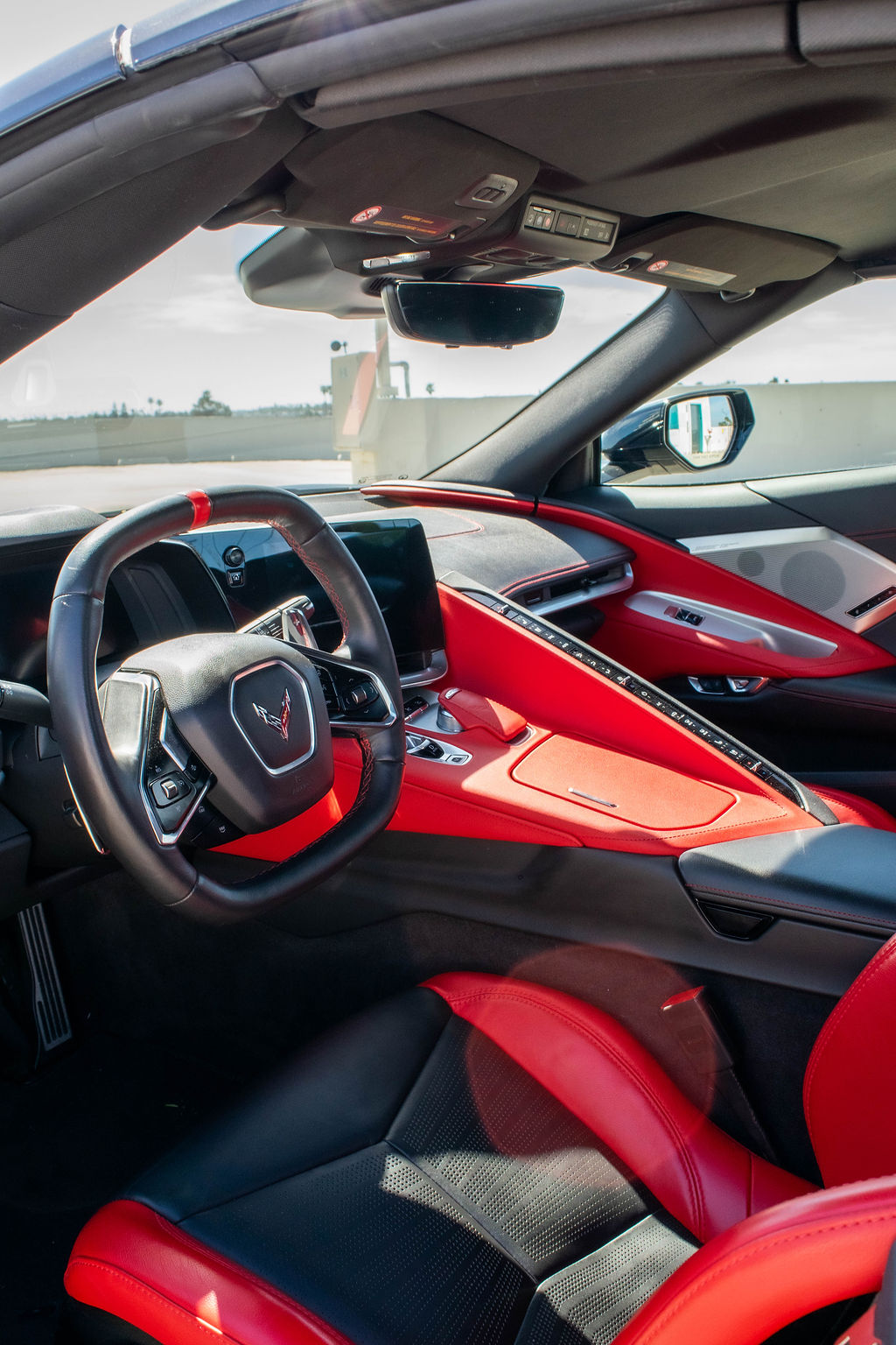 Black Chevrolet Corvette C8 Stingray sports car rental delivered across Orange County, CA, Black and Red interior