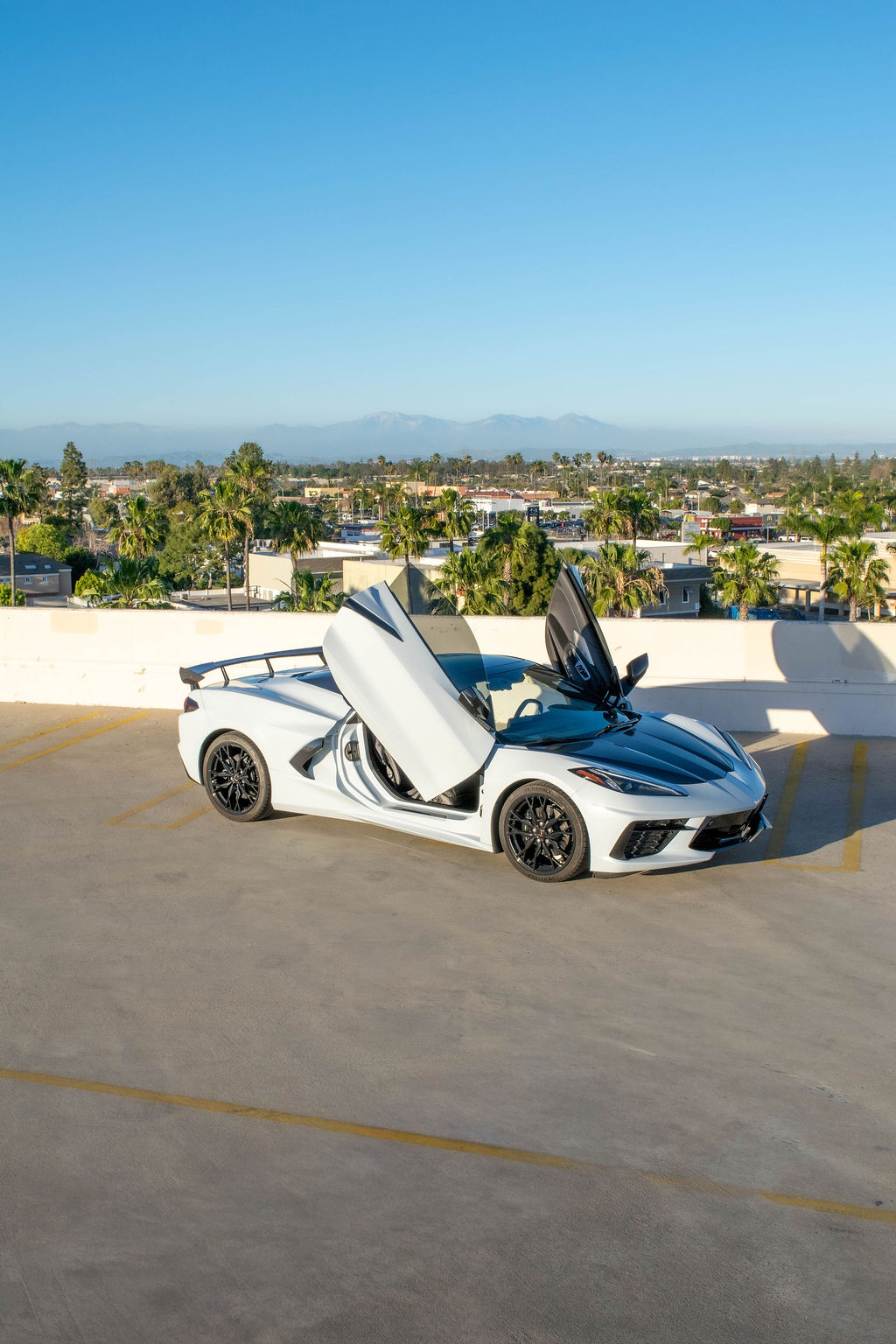 White Chevrolet Corvette C8 Stingray sports car with 2 seat cabin, Orange County rental