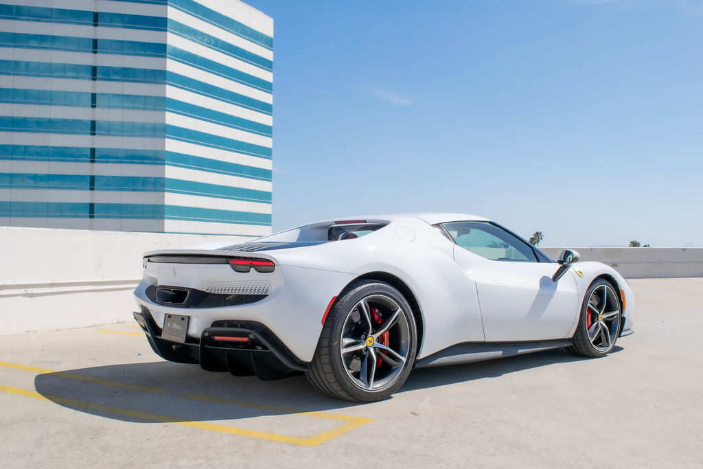 White Ferrari 296 GTB supercar on rent in Orange County, Red interior