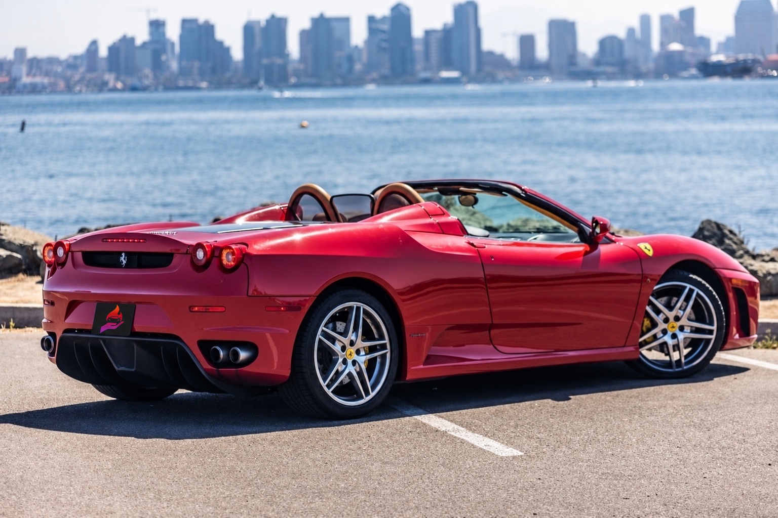 Red Ferrari F430 Spider, rear three-quarter view, a 483 hp V8 convertible to rent in Southern California