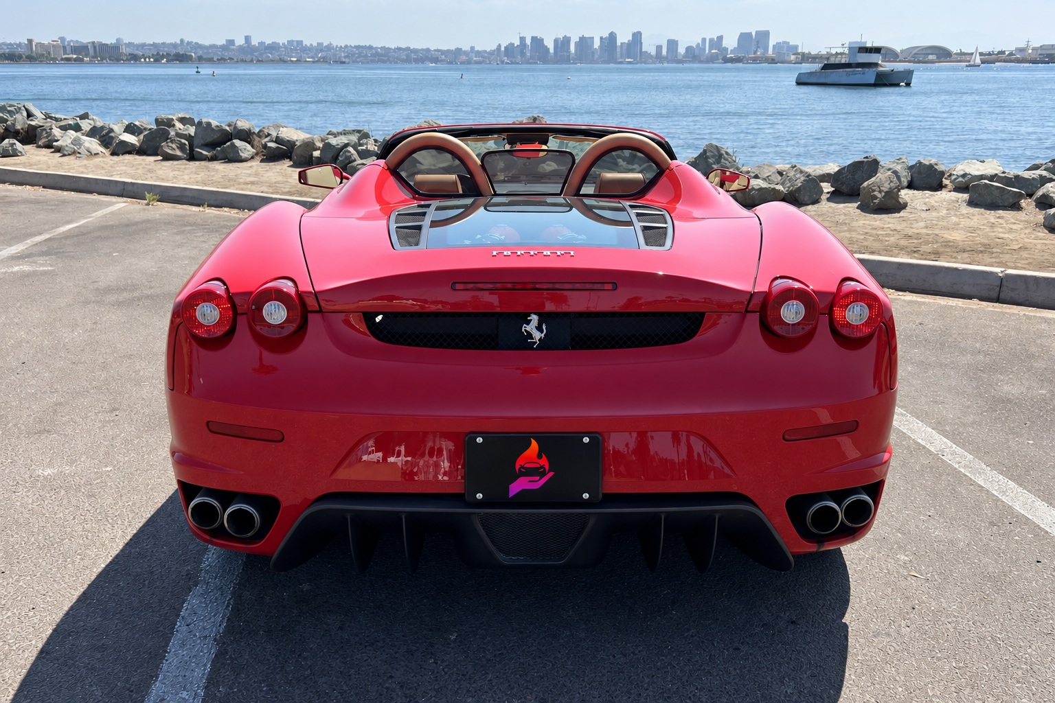 Rear view of the red Ferrari F430 Spider, 4 round taillights, quad exhaust and the glass engine cover