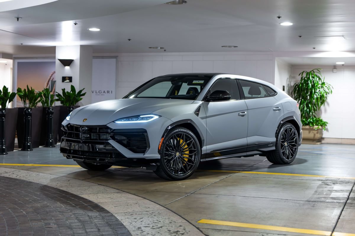 Grey Lamborghini Urus SE parked under a hotel portico in Beverly Hills, front three-quarter view