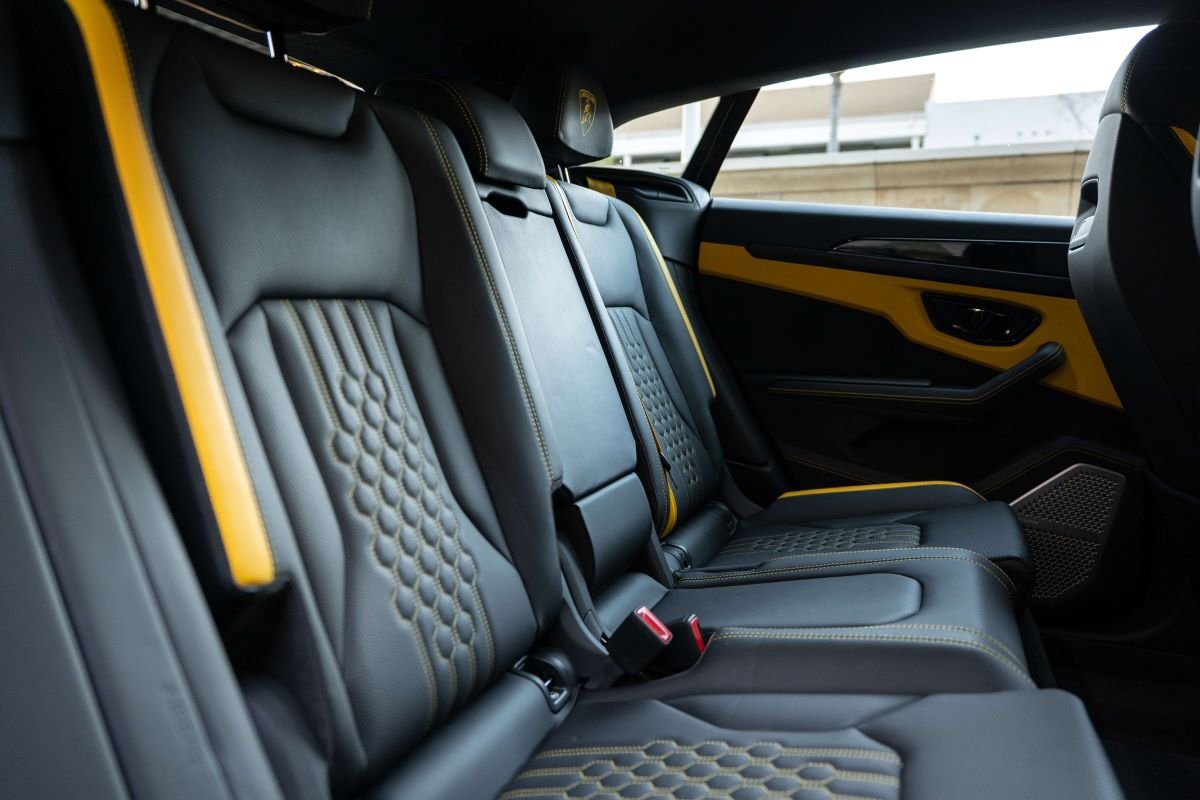 Rear seats of the Urus SE in hexagon-quilted black leather with yellow belts and yellow door panels