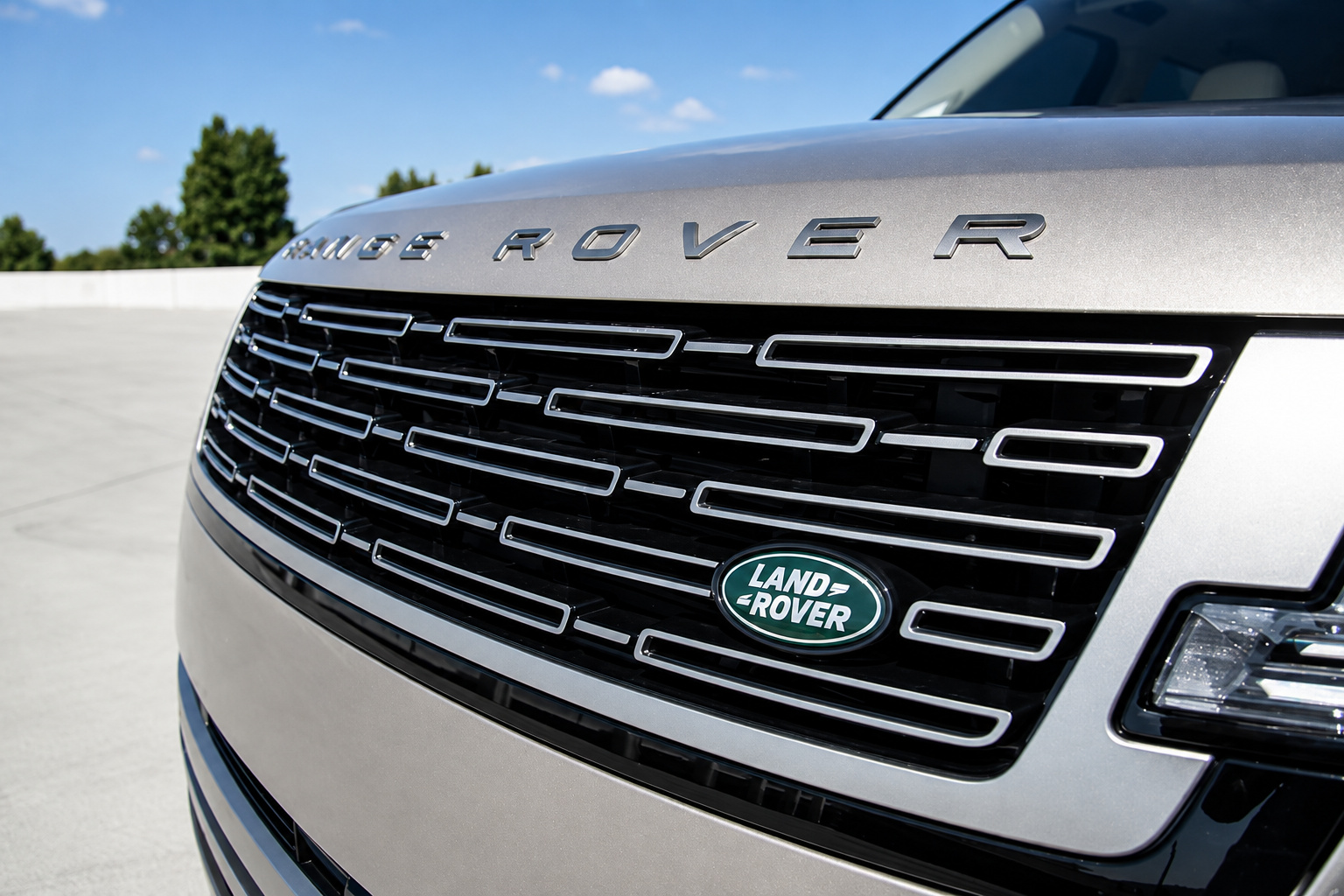 Front grille of the champagne Range Rover HSE with the Land Rover badge and the hood lettering