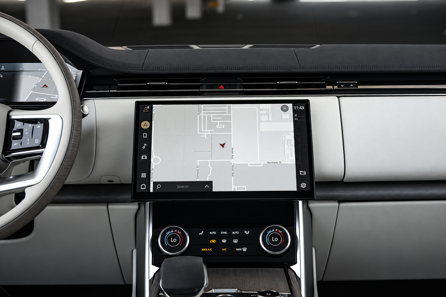 Centre touchscreen and climate dials of the Range Rover HSE with the light wood and grey trim