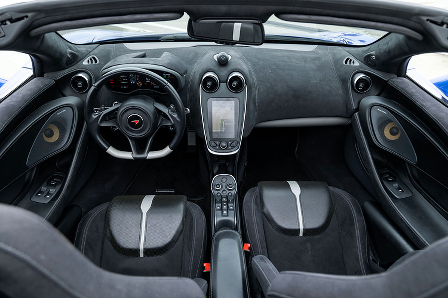 Black alcantara cabin of the 570S Spider from above, white-striped seats, centre screen and gear buttons