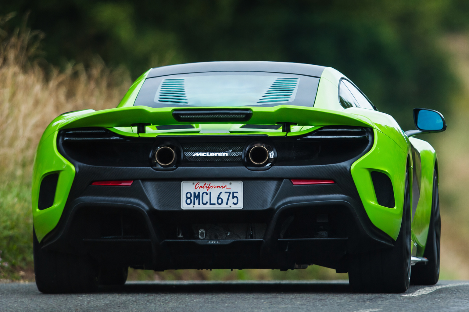 Rear view of the Napier Green McLaren 675LT with the 2 center-exit exhausts, airbrake and diffuser