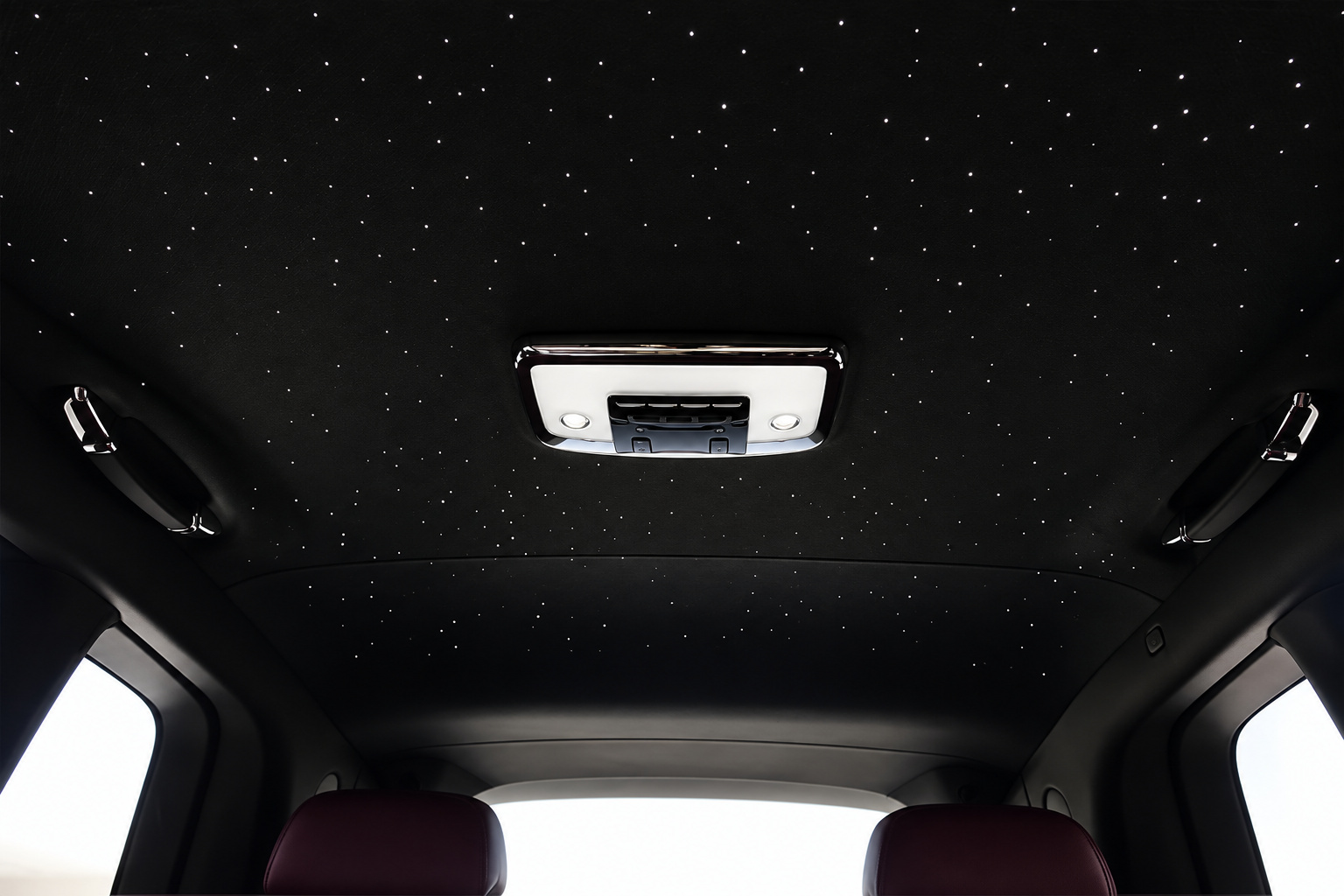 Starlight headliner in the white Cullinan, hundreds of fiber-optic points above the purple rear seats