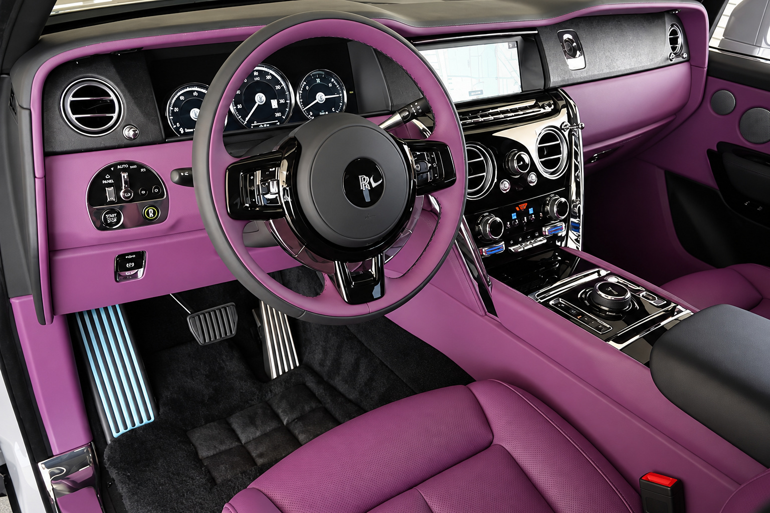 Driver's seat of the white Cullinan, purple leather dash and door, black steering wheel and the gauge cluster