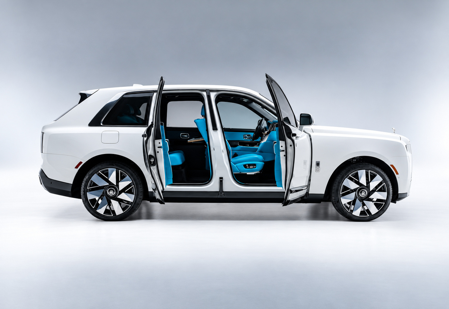White Cullinan Series II in profile with all 4 coach doors open on the light blue cabin