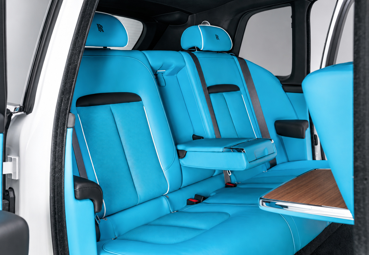 Sky blue leather rear bench of the white Cullinan Series II with the wood picnic table folded down