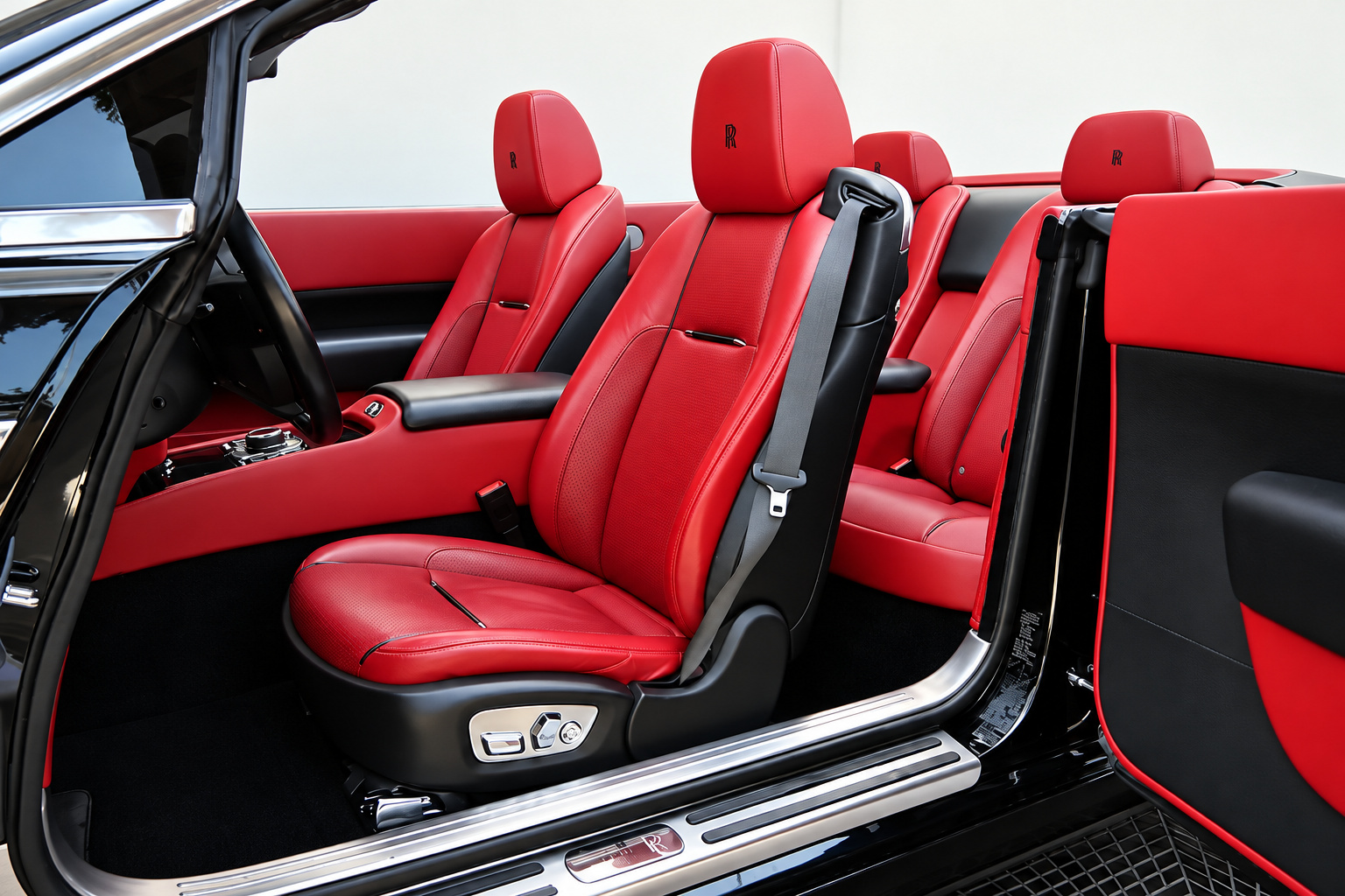 Driver's seat of the black Dawn in bright red leather seen through the open rear-hinged coach door