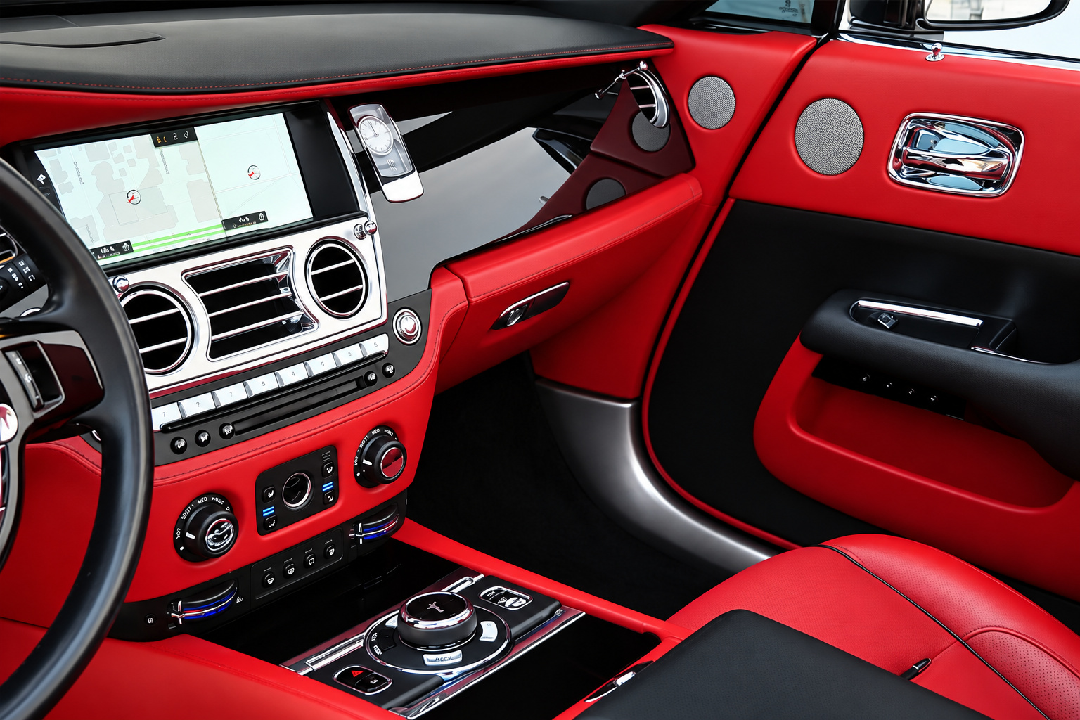 Dash and center console of the black Dawn, red leather over black with the navigation screen and chrome vents