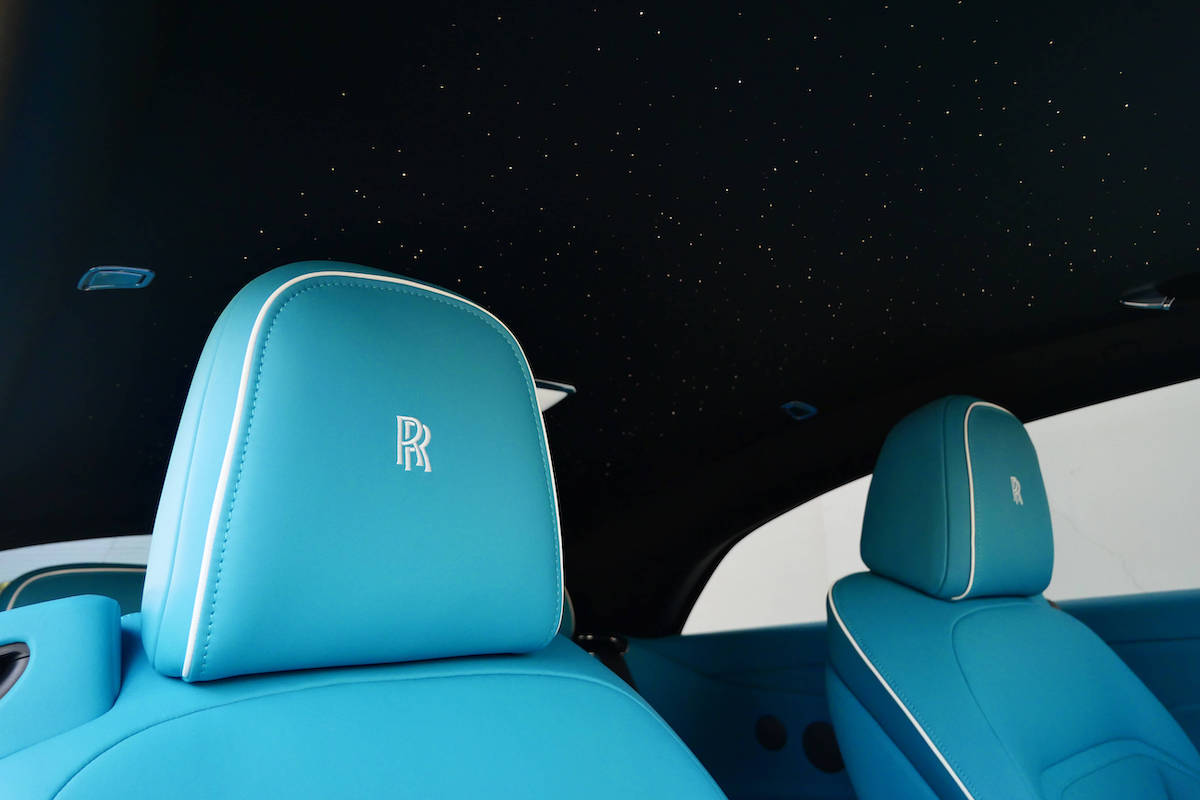 Embroidered RR headrest in turquoise leather beneath the Spectre starlight headliner