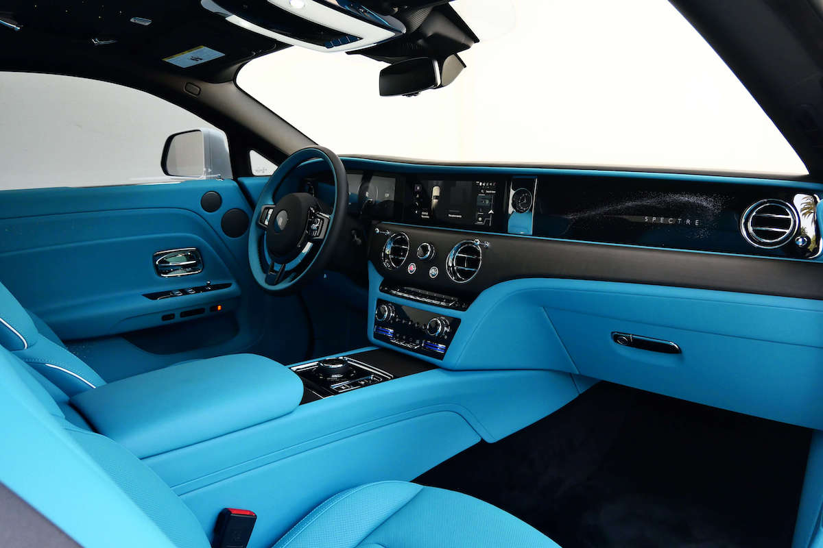 Passenger-side view of the Spectre dash, turquoise leather, chrome vents and the center screen